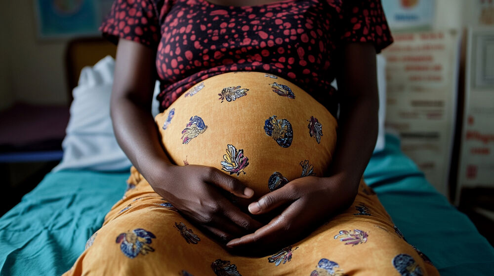 Pregnant woman cradling her baby bump Pregnant woman cradling her baby bump