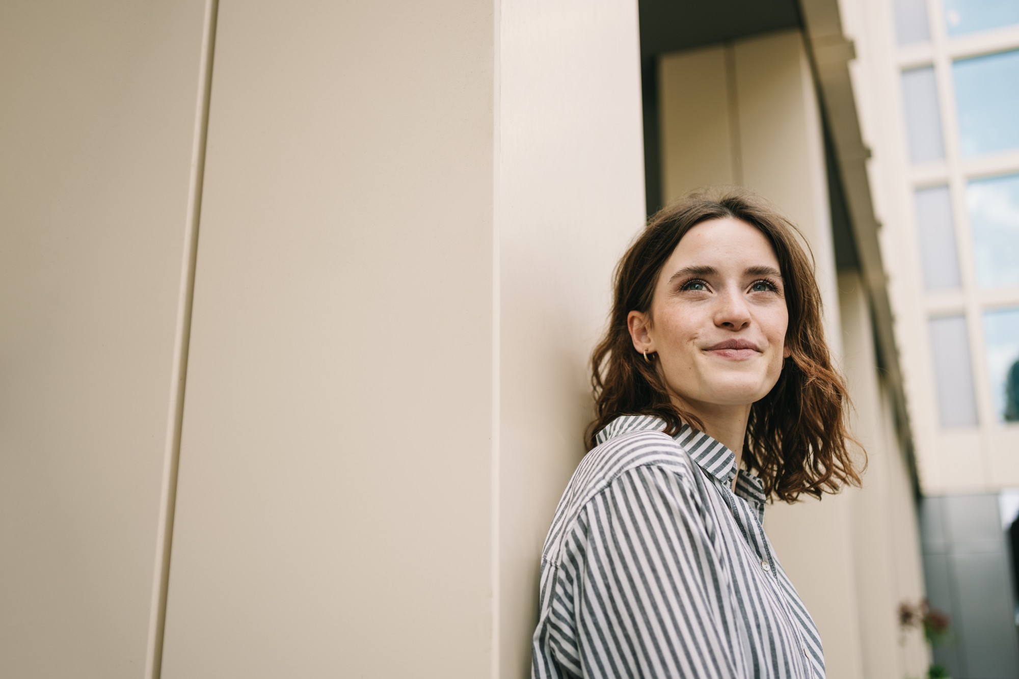 Young woman looking ahead with a hopeful smile