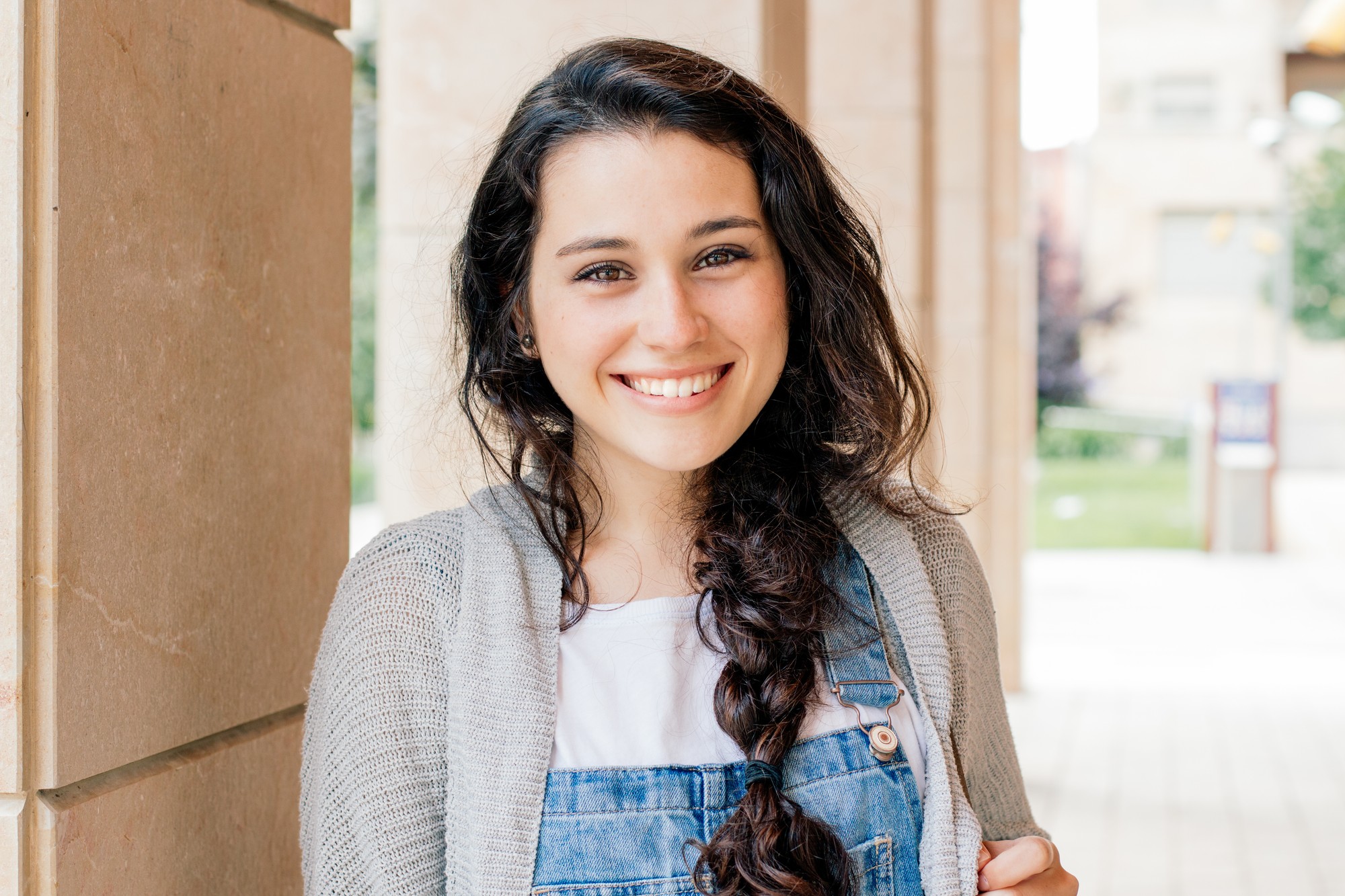 Young woman smiling Young woman smiling in a sunlit walkway